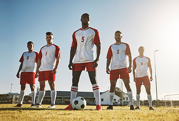 Image showing Soccer player, team and sports training on soccer field by men standing with ball, power and strong mindset. Football, fitness and man football players united in support on football field for workout