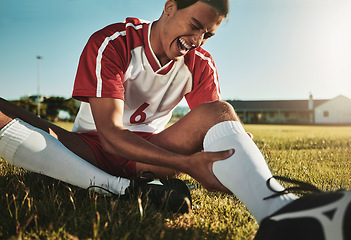 Image showing Man, soccer and sport leg injury suffering in pain, agony and discomfort during training match or game on the field. Male football player screaming holding painful area in sports accident on grass