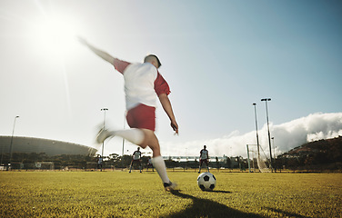 Image showing Motion blur, soccer field and man kick ball to player on stadium pitch in sports competition game to score goals, winning and fitness. Football athlete action, energy or dynamic shot outdoor training