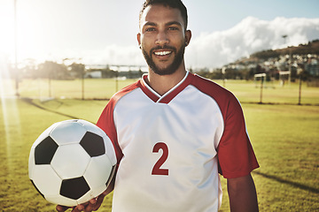 Image showing Portrait, soccer player and man with a soccer ball at a field, happy, smile and excited about sports goal at soccer field. Football player, fitness and guy at a football field for training workout