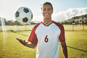 Image showing Soccer, portrait and man on a field for training, sports or game in summer. Happy, excited and young athlete catching a football during exercise, fitness and cardio on a sport ground in a park