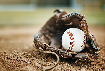 Image showing Baseball, leather glove and ball on pitch sand after fitness, workout or training for match or competition. Zoom, texture and softball mitt on field for sports team, wellness exercise or stadium game