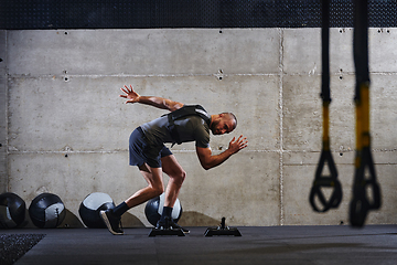 Image showing A fit couple in a modern gym, engaging in running exercises and showcasing their athletic prowess with a dynamic start.