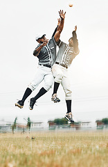 Image showing Sports, baseball and men jump to catch ball on field during game, action and motion with teamwork. Fitness, baseball team and black man jumping with teammate to help with catching for strike out.