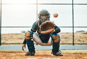 Image showing Baseball, catch and sports at the pitch for game, point or score with the ball on a field in the outdoors. Black man pitcher with mitt in sport training, exercise and fitness in competitive match