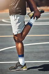 Image showing Basketball court, man and stretching legs outdoor for exercise, muscle energy and healthy training of sports game. Closeup basketball player start body warm up, feet balance and energy in competition