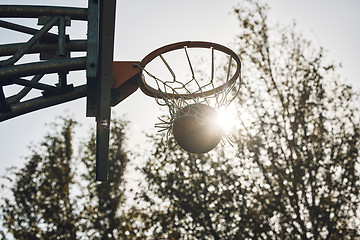 Image showing Basketball court net, silhouette and sports playing game, competition and action match outdoor. Empty background winning, goal target aim and shooting hoops skills training, hobby and fun performance