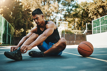 Image showing Basketball court, man and shoes prepare for training at recreation and athlete facility. Sports, exercise and fitness male with lace tie getting ready for ball game workout and cardio.