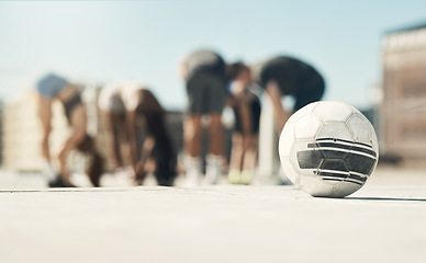 Image showing Football, soccer ball and sports group of men and women exercise, training and workout on urban rooftop. Street ball, concrete training and fitness people for team practice for game or competiton