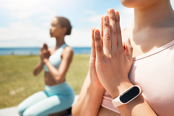 Image showing Hands, meditation and smartwatch by friends doing yoga on field for fitness, health and peace with balance. Zen, training and cardio tracking on watch with women in yoga pose, bonding and meditating
