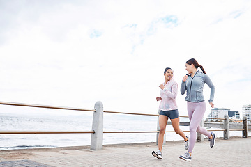 Image showing Running, friends and runner women by the sea in nature for fitness, wellness and exercise. Smile of people in health cardio training, sports and strong workout with happiness from athlete motivation
