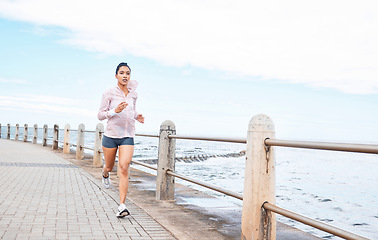 Image showing Fitness, health or woman running by the beach, ocean or sea for wellness, workout or exercise for marathon or event. Motivation or runner sports girl training, run for cardio or healthy lifestyle