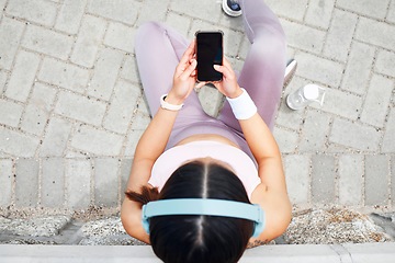 Image showing Smartphone, fitness and headphones of woman listening to music on mobile app screen, audio live streaming or outdoor 5g social networking. Sports, runner or athlete girl with tech using phone above