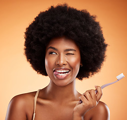 Image showing Black woman, toothbrush and for dental wellness for teeth whitening, protection and oral hygiene on orange background. Afro, healthy and smile of a comic lady posing for mouth cleaning and beauty