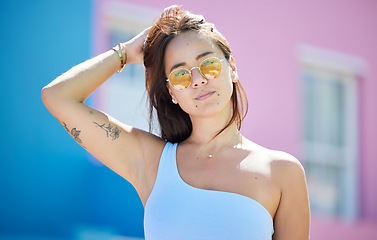 Image showing City, fashion and portrait of woman with sunglasses for cool and trendy summer style on holiday. Asian, Gen Z and urban fashionista girl on vacation break in sunlight relaxing with retro glasses.