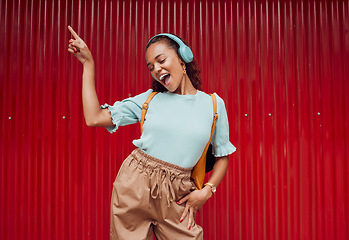 Image showing Music, dance and woman in the city against a red background during a travel holiday in Amsterdam in summer. Happy, smile and girl with freedom, 5g radio and singing with headphones on vacation