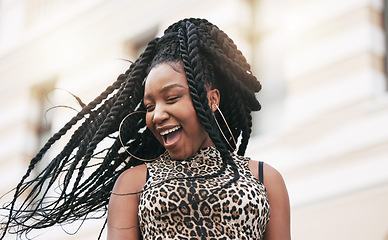 Image showing Hair, freedom and fashion with a fun black woman in the city on a summer day feeling cheerful or carefree. Braids, free and trendy with a young female in town on an urban background with flare