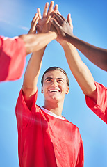 Image showing High five, soccer and team in celebration of a goal and winning in a sports game or match outdoors in summer in Brazil. Success, fitness and happy friends or athletes reaching football score targets