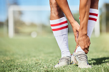 Image showing Soccer, sports and ankle pain, injury or accident on a field during a game, exercise or training. Muscle sprain, broken joint or medical emergency of a man athlete at a football pitch during a match.