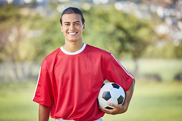 Image showing Soccer, sports and fitness with a man athlete holding a ball on a field or grass pitch for training. Football, workout and exercise with a male player outdoor for health, wellness or practice