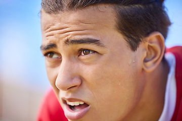 Image showing Soccer player, tired and sweat on face after sports training, game or match feeling exhausted and breathing heavy outdoor after workout. Football, exercise and athlete man taking a break on pitch