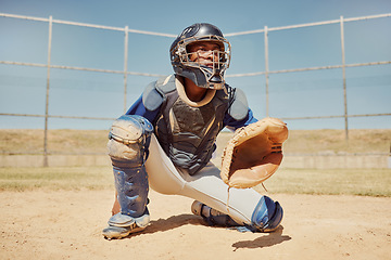 Image showing Baseball, sports and man waiting on a field during a game, competition or training. Athlete catcher playing a sport with focus for exercise and fitness in nature or a park at an event in summer