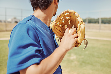 Image showing Baseball, sports and man pitching during a game, training and professional event on a field. Back of athlete ready to throw a ball with a glove during an outdoor competition, fitness or cardio