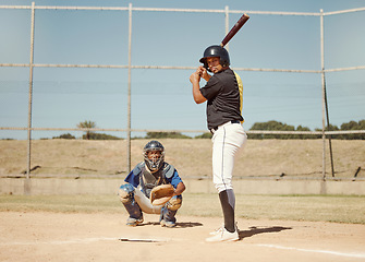 Image showing Baseball, pitcher and man with a bat on pitch playing a match or sport training as a team. Fitness, sports and men athletes practicing pitching and batting before a softball game on an outdoor field.