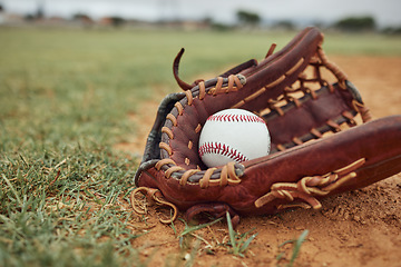 Image showing Baseball, ball and glove on an outdoor pitch for sport training, fitness or a tournament game. Exercise, sports equipment and softball match on a professional field or stadium with grass and sand.