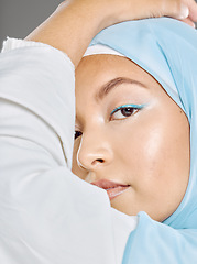 Image showing Muslim, woman face and beauty, makeup and hijab with Islamic fashion, natural cosmetics advertising with studio background. Beautiful, young and traditional head scarf, glow in closeup portrait.