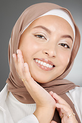 Image showing Muslim, beauty woman or arab model with smile for portrait, makeup or facial skincare in grey studio background. Skin, face or happy islamic girl with fashion, confident or headshot with brown hijab