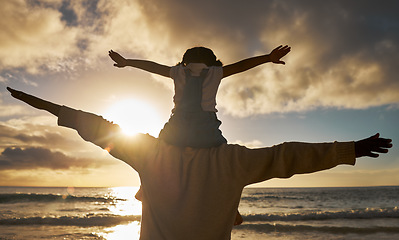 Image showing Father, child and shoulders flying on the beach enjoying the sunset together for family bonding in the outdoors. Dad with kid pretend to fly on piggyback fun in nature for relationship, love and care