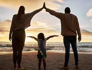 Image showing Beach, love and family in unity together while on summer vacation, journey or adventure at the sea. Mother, father and girl child bonding in nature by the ocean water with sunset on seaside holiday.
