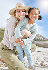 Image showing Hug, mother and child, together and on the beach, love and care, bonding in portrait for travel outdoor on the seaside. Happy, woman and girl, family and summer holiday, adventure and smile.
