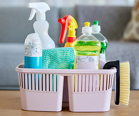 Image showing Cleaning supplies, brush and basket tools on table in home living room for hygiene. Cleaning products, spring cleaning and equipment for creating germ free living space, sanitizing or washing.