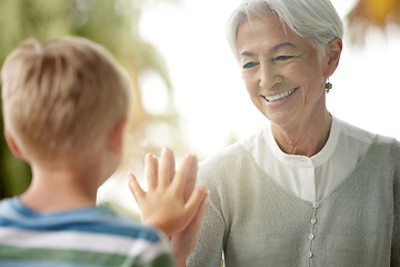 Image showing Covid, grandmother and child touching window for safety, social distancing and risk in covid 19 pandemic. Family, love and boy connect hand with grandma on glass in isolation, quarantine and lockdown