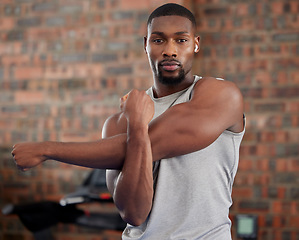 Image showing Man, earphones or stretching arms in gym workout, training or exercise for health, wellness or strong muscles. Portrait, bodybuilder or black person in warmup or listening to motivation podcast radio