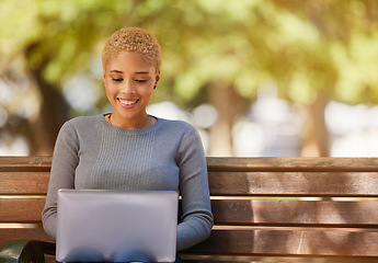 Image showing Woman, laptop and smile in park while on social media, reading or writing on web. Black woman, writer and happy with computer in sunshine to relax outdoor by trees for study, poetry and technology