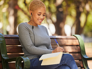 Image showing Happy, black woman and writer outdoor with music to relax, enjoy sunny day and make notes for studies. Young female, lady student with notebook and podcast, writing in diary or journal outside.
