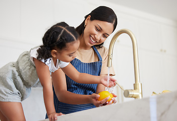 Image showing Cleaning, mother and child washing vegetables with water for lunch, nutrition or breakfast in the kitchen of their house. Child learning to clean food while cooking with her mom before dinner