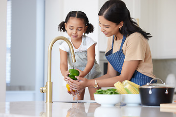 Image showing Kitchen, mother and child washing vegetable to cook dinner, lunch or breakfast together at house. Happiness, bonding and mom cleaning a green pepper before cooking food with girl kid in family home.