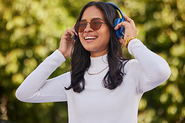 Image showing Happy, woman and headphones listening to music for fun online audio streaming in the nature outdoors. Stylish female enjoying quality track with headset for stress relief, weekend and relax at a park