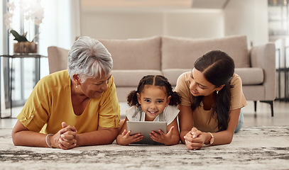 Image showing Tablet, children and family with a girl, mother and grandmother streaming or watching movies online together. Kids, internet and love with a woman, parent and daughter bonding while lying on a floor
