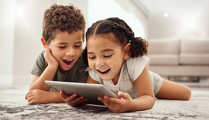 Image showing Tablet, children and family with a brother and sister watching movies on a living room floor together. Internet, kids and technology with a girl and boy streaming online subscription service at home