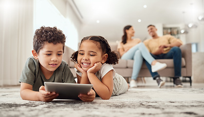 Image showing Learning, tablet and children streaming a video on technology on the living room floor of their house. Education, happiness and movies on technology for kids with parents on the sofa in their home