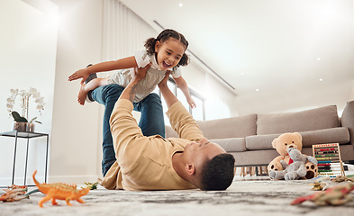 Image showing Happy family, father and girl playing in a house with freedom, bonding and enjoying quality time together. Happiness, smile and child flying in dads arms on the floor on a weekend at home in Portugal