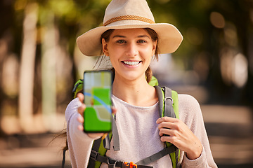 Image showing Hiking, phone and woman with gps, map and navigation app on screen while hiking in forest, happy and relax. Portrait, girl and internet location for hiker on adventure in nature, excited and smiling