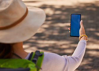 Image showing Summer, hiking and mockup of phone in hand of woman on adventure in city. Travel, explore and tourist using smartphone for directions, digital map or fitness tracking with blue screen for marketing