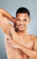 Image showing Man shaving armpit body hair for self care, hygiene and beauty skincare routine, wellness and epilation cleaning. Happy, smile and mockup portrait of young person grooming isolated on gray background