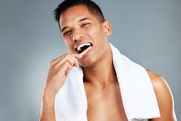 Image showing Man, toothbrush and teeth for dental hygiene in clean, fresh and wash for healthcare against a grey studio background. Portrait of a toothy male brushing mouth for oral and gum care treatment